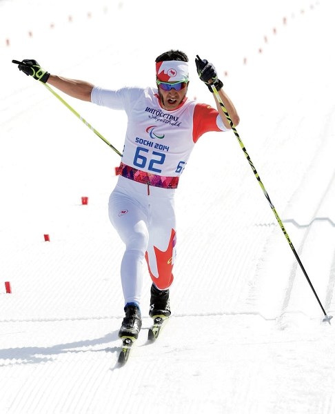 Brian McKeever hits the finish line to claim gold in the Paralympic 20-kilometre classic cross-country ski race Monday (March 10).