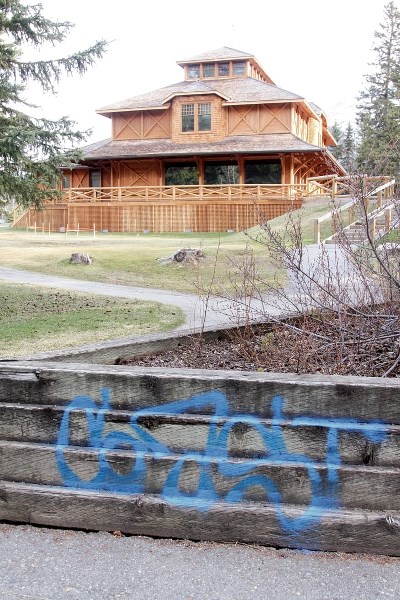 Graffiti is seen on wooden planters in Banff’s Central Park.