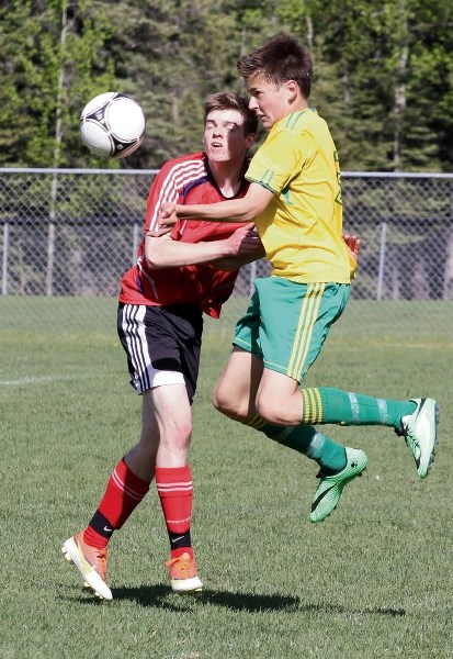 CCHS Crusader Soren Kwasny takes a header in front of a Strathmore Spartan, Monday (May 26) at Millennium Park in Canmore. Canmore won 4-2 to clinch a league title.