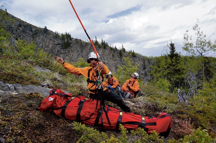 Kluane resource conservation staff members Scott Stewart, Sarah Chisholm and David Blakeburn train with a Bauman bag and helicopter sling rescue system on Paint Mountain near 