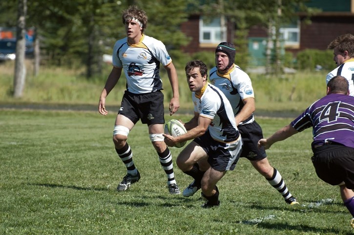 Banff Bear Simon MacDonald dekes a Red Deer Titan during Calgary Rugby Union action at Banff’s Rec Grounds, Saturday (Aug. 9).