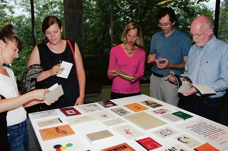 Attendees take in the Verlag Notes exhibition of artists’ books on display at The Banff Centre’s Eric Harvie Theatre, West Lobby on Thursday (Aug. 14). The exhibition is a
