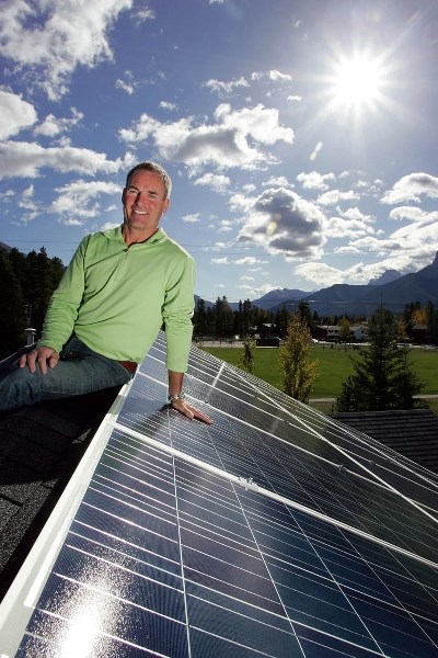 Canmore’s Joey O’Brien shows off the 40-panel solar energy system on the roof of his family home.