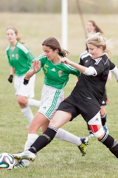 Canmore Collegiate High School’s Journey Hames fights for possession of the ball during the Crusaders’ game against Holy Trinity Academy in Carstairs.