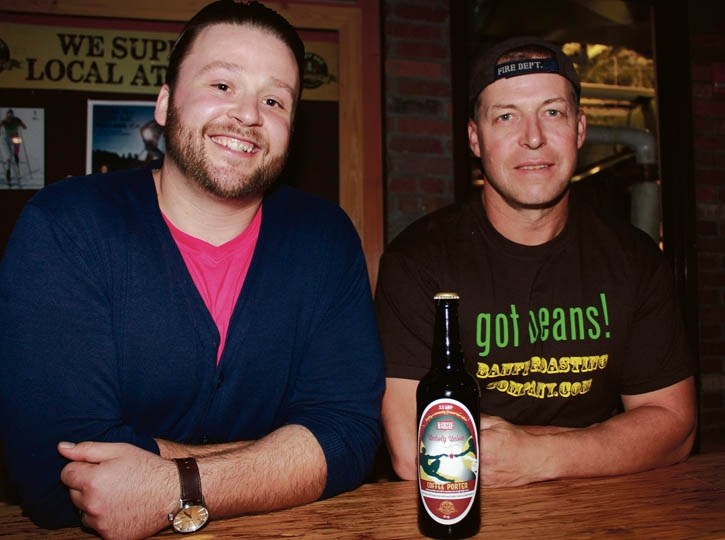 Banff Ave Brewing Co. general manager Pete Grottenberg, left, and brewmaster Kent Paterson with a bottle of Unholy Union coffee porter. The seasonal beer was made as a joint