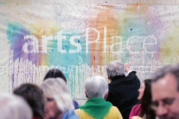 Visitors put their mark on a canvas following a tour through the future home of artsPlace in Canmore Friday (Jan. 9).