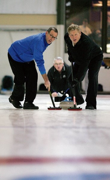 Team Websters Richard LaPlace and Dave Oliver sweep Frank Watsons shot during the Canmore Bonspiel at the Canmore Golf and Curling Club.