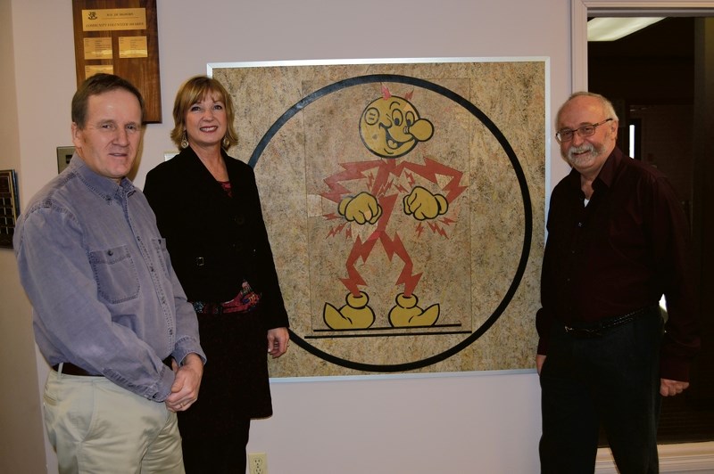The restored Reddy Kilowatt logo displayed in the MD of Bighorn office in Exshaw. Martin Buckley, Bighorn chief adminstrative officer, left, Tavia Tilson, Armstrong World