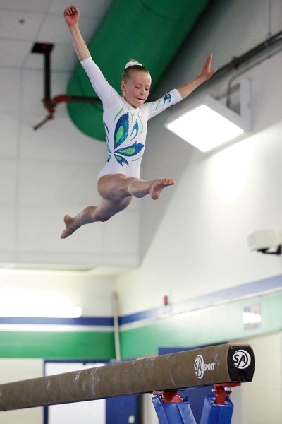 Ivy Tupper floats above the beam during her sweep of all four aparatus and first all around at the Summit Invitational gymnastics meet in Canmore.