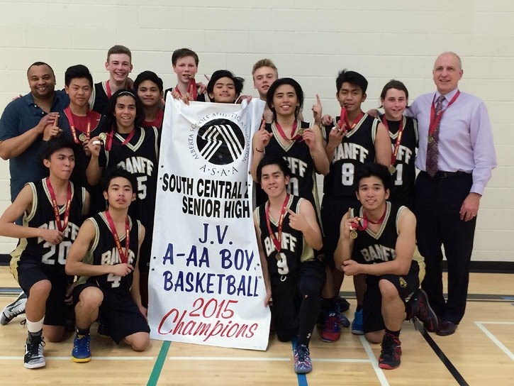 The Banff Bears celebrate with the South Central Zone senior high basketball banner.