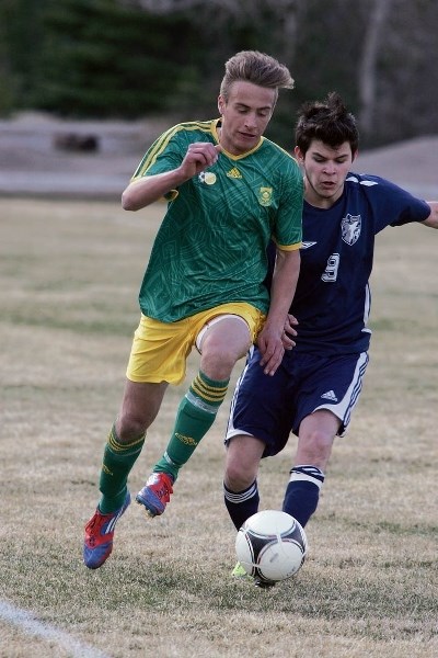 Ty Godfrey (L) uses his speed during Canmores 5-0 victory over Notre Dame Collegiate at Millennium Field Wednesday (April 22).