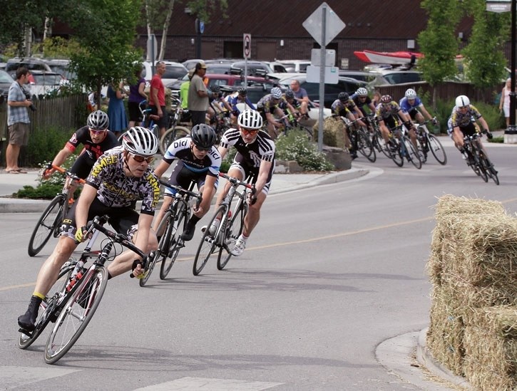 RMCC Cat 3 rider James Kendal leads two groups of cyclists through an S section of the criterium track in downtown Canmore Saturday (July 11). Kendal took fourth in the event.
