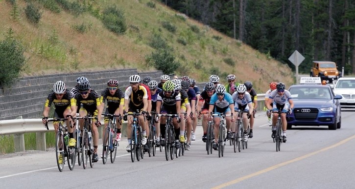 RMCC riders Mitch Fennell and James Kendal lead a pack along Three Sisters Drive during a Rundle Mountain Bike Fest Cat 3 road race on Sunday (July 12).
