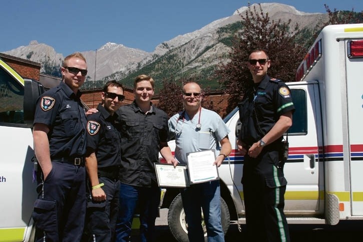 Canmore resident Liam Hawkins receives the EMS Citizen Recognition Award on Saturday (July 18) at the Canmore Hospital. (Left to right): Joe Casurella, Nakoda EMT; Sylvain