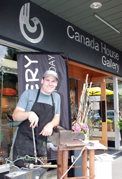Artist and architectural blacksmith Paul Reimer takes a break during Canada House Gallery’s Artists’ Demo Day in Banff on Saturday (Aug. 8).