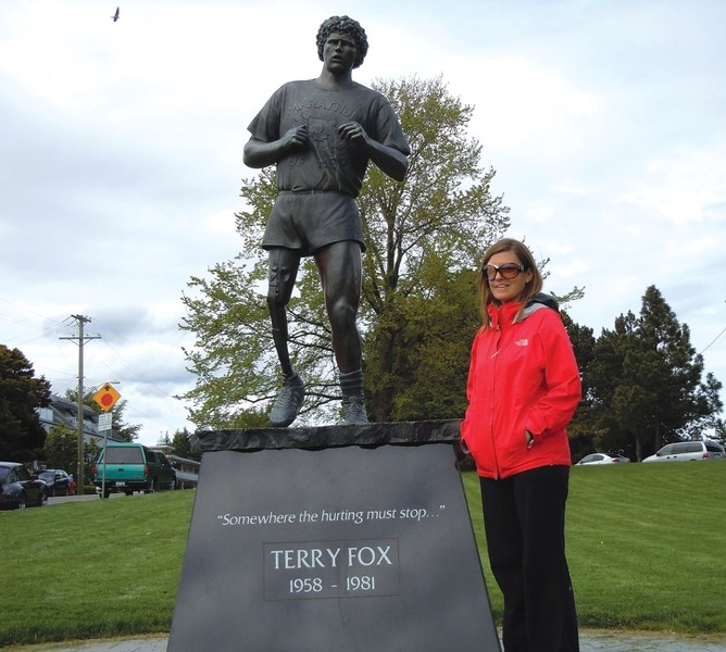 Michelle Fuller by a statue of Terry Fox at Mile Zero in Victoria, B.C.