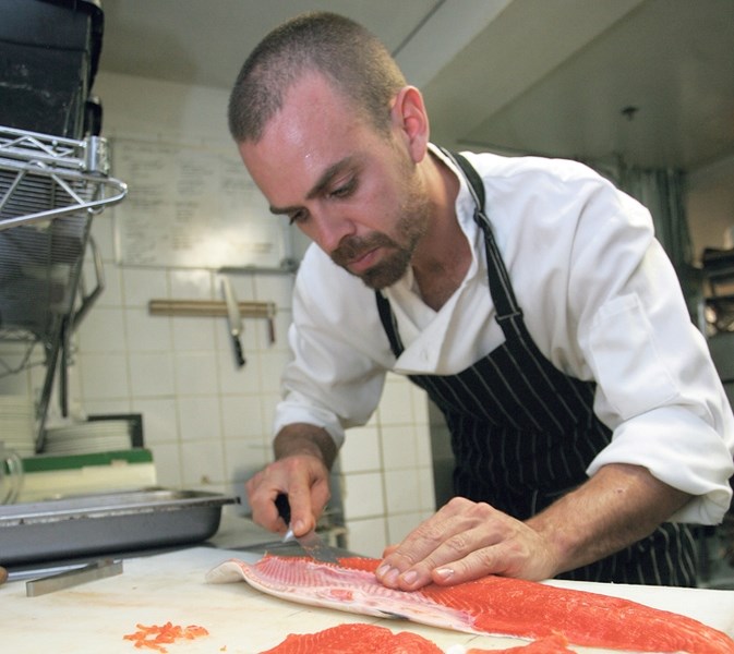 Sous chef David Cousineau of The Bison prepares salmon.