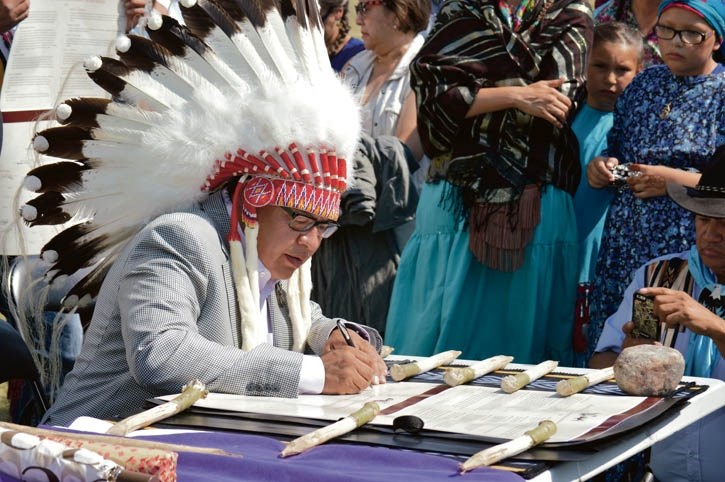 Chiniki Chief Aaron Young signs the Buffalo Treaty on Aug. 13 at the Banff Indian Grounds.