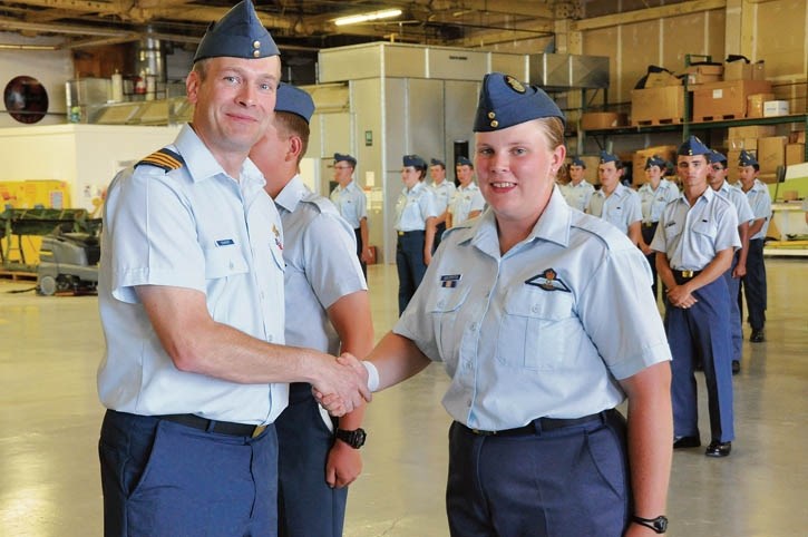 Flight Sgt. Catherine Van Dorsten is congratulated by Lt. Col. John Schwindt after being presented with her glider wings.