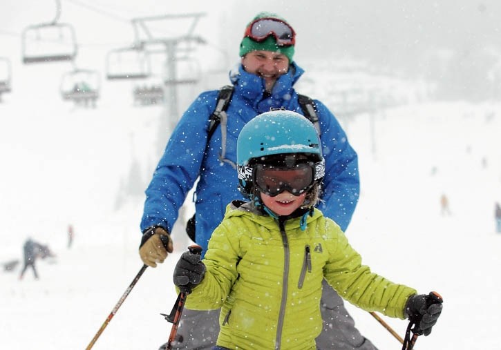 Tristan Fortin and his dad JP enjoy fantastic ski conditions at Mount Norquay for the 2013 opening on Nov. 2. Local skiers will be hoping for similar conditions to arrive
