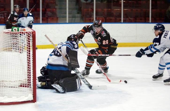Eagles goaltender Ryan Bontorin slides into position as Coy Prevost takes the stick of towering Lloydminster Bobcats captain Taylor Mulder during Saturday’s (Dec. 20) matchup.