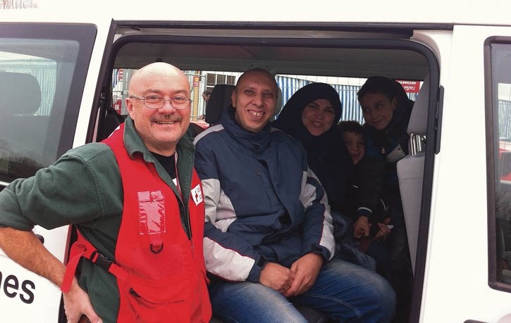 Dave Bateman with a group of Syrian refugees at a camp in Erding, Germany. Bateman spent a month volunteering at the camp to wrap up 2015.