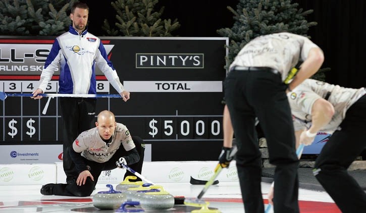 Brad Gushue stands over Pat Simmons during their matchups Saturday (Jan. 9).