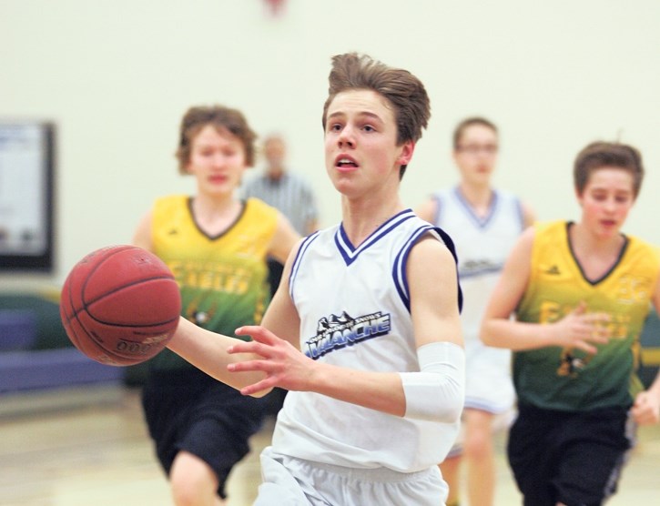 Noah Arvisais carries the ball for the OLS Avalanche during the team’s home court zone basketball tournament.