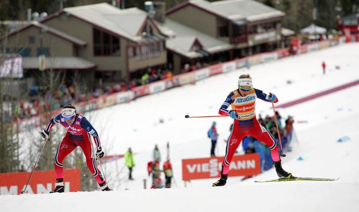 Race winner Heidi Weng, left, and second place Therese Johaug power uphill as they lead the way in the Ski Tour Canada skiathlon event at the Canmore Nordic Centre, Wednesday 