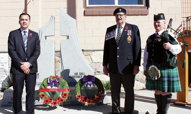 Banff-Airdrie MP Blake Richards,left, Canmore Royal Legion branch president Darrel Jones and and Murial Davidson during the laying of wreaths at Canmore Legion, Saturday