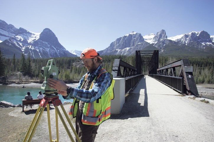 McElhanney surveyor Arley Poutler measures the area near Canmore’s Engine Bridge.