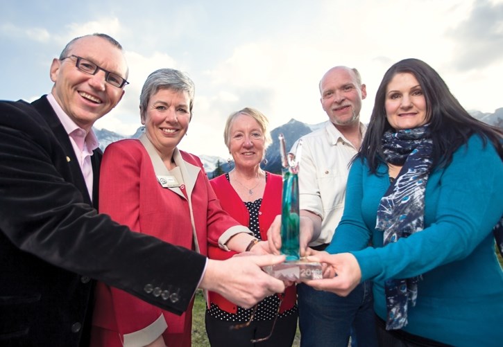 Derek Ryder, left, Karen Irvine, Anne Gildey, Mike Walters, and Kelly Armour hold up the 2016 Paul Greig Memorial Award for Environmental Stewardship at the Canmore