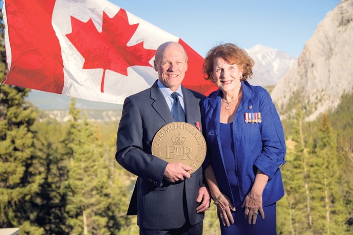 The Honourable Lois Mitchell, Lieutenant Governor for Alberta, presents a bronze plaque commemorating Banff’s Commonwealth Walkway to Banff-Canmore Community Foundation chair 