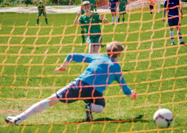 Henrik Rathjan scores the winning goal against the Bow Valley Bobcats to clinch Canmore Collegiate High School’s second straight Zones title Saturday (June 4) at Millennium