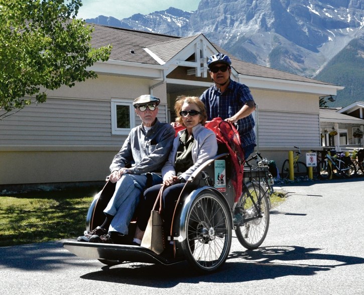 Olga Taylor and Jim Sunstrum take a cruise with Dan Seto at the pedal for a Cycling Without Age tour in Canmore on Monday (June 20).