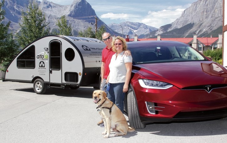 Rolf Oetter, Silke Sommerfeld and Kye with their Tesla X and Alto camper. The pair stopped at Canmore’s Rocky Mountain Inn to recharge at a Tesla supercharger station en