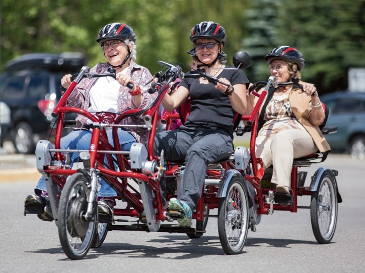 Kathleen LeBlance, left, and Annie Tredray demonstrate a new mobility bike at the Banff Hospital on Friday (July 8).
