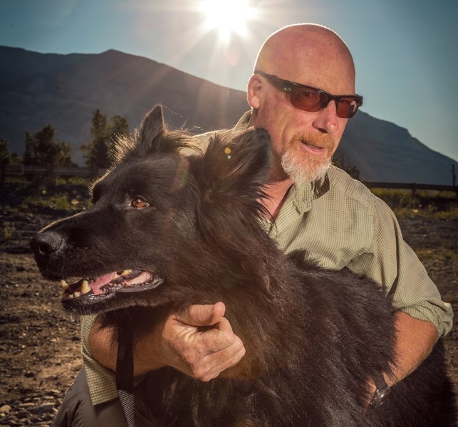 Mike Henderson, retired warden and dog handler for Parks Canada in Banff, poses with Cazz near Cougar Creek in Canmore in 2018. RMO FILE PHOTO