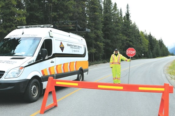 Standish Traffic Control’s Pyke Campbell redirects traffic on the closed road leading to Johnson Lake on Tuesday (Aug. 23).