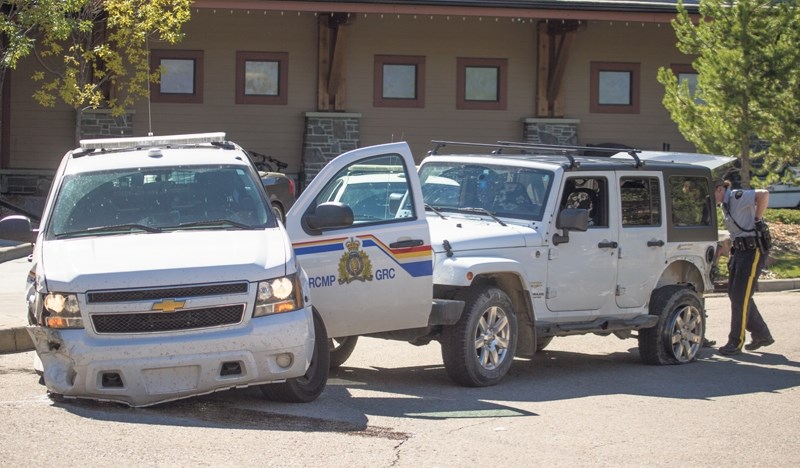 A Jeep stolen in Cochrane crashed into an RCMP truck at about 12:45 p.m. near the Stewart Creek Golf Course clubhouse, Tuesday (Sept. 13).