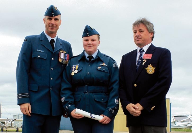 Presenting Power Pilots wings to Warrant Officer Second Class Catherine Van Dorsten was Major Phil Shilling, CD Flight Commander at CFFTS Moose Jaw and Brian Lewis, Assistant 