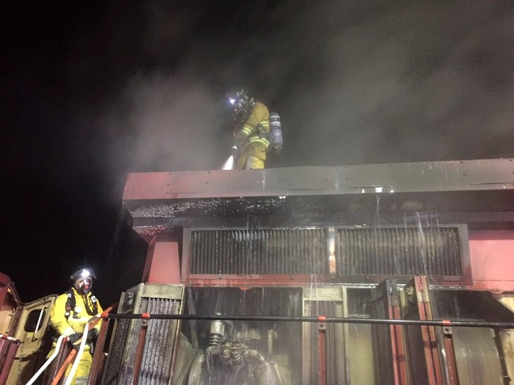 Firefighter Uriel Dostie cools down the locomotive with firefighter Stuart Back standing by, Monday (Nov. 21).