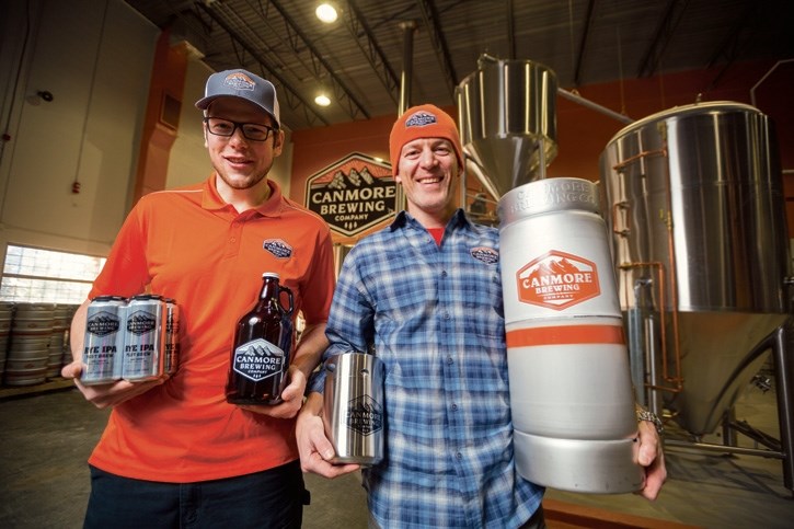 Darren Steffler, left, and Brian Dunn display some of the products Canmore Brewing Company will provide to customers from their new brewery in Canmore, Thursday (Jan. 12).