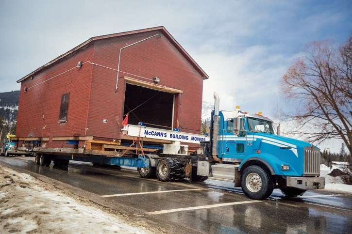 The historic icebox building is moved across the rail yard at the Banff Railway Station on Tuesday (March 14).