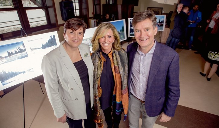 Banffs mayor Karen Sorensen, left, along with Jan and Adam Waterous from Liricon Capital, stand in front of revitalization images at the Banff Train Station on Tuesday