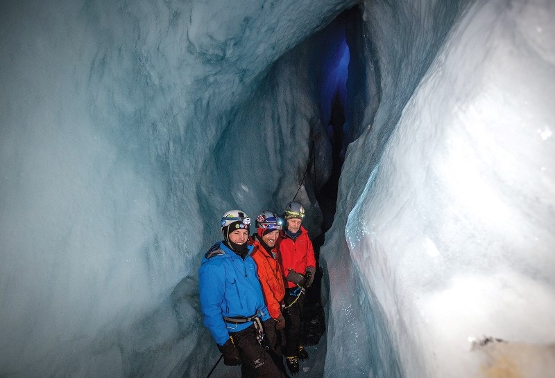 Johnathan Boutin from Canada Science and Technology Museums, left, adventurer Will Gadd, and University of Alberta glaciologist Martin Sharp explore ice cave passages deep