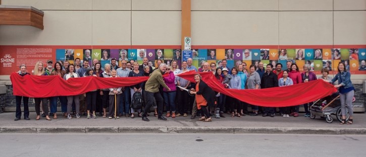 Outgoing BCCF executive director Lorraine Widmer-Carson gets and assists from Harvey Locke in cutting a ribbon to open the SHINE on the side of Banff IGA, Tuesday (June 13).