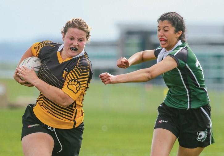 Banff Bears player Holly Phillips, left, deftly evades an attempt by Springbank to tackle at the Calgary Rugby Union on Thursday (June 1). Phillips was selected to Canada’s