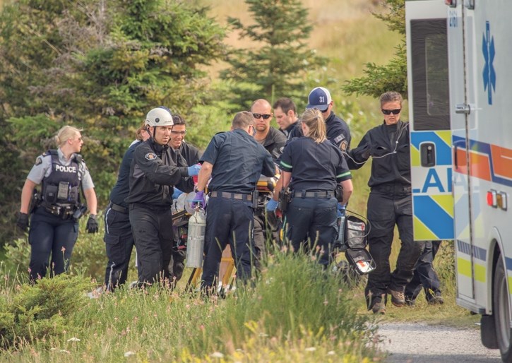 EMS, Canmore Fire-Rescue and RCMP members perform CPR on a male who drowned in Quarry Lake, Thursday (July 20).