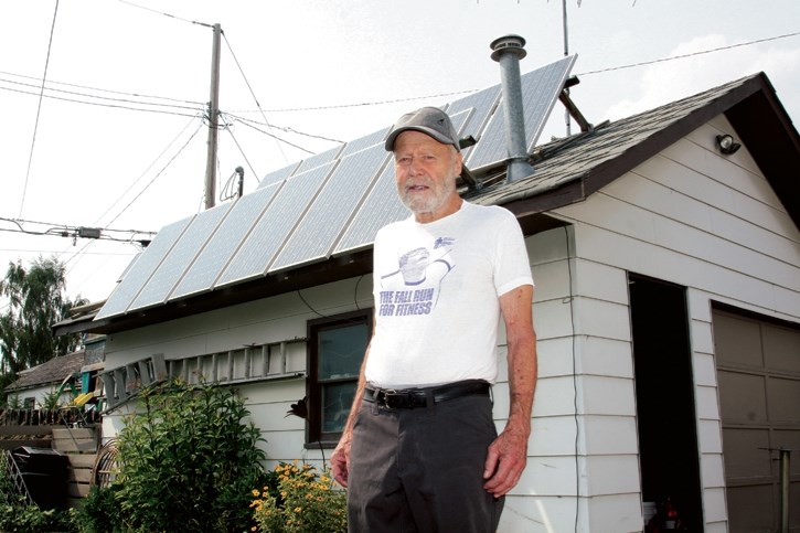 Bill Hamilton with the solar array on his Exshaw garage.
